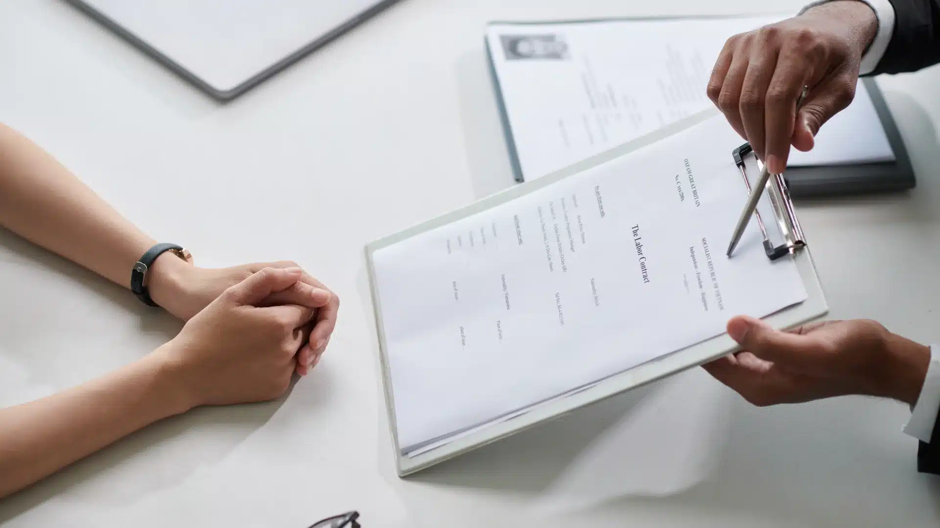 Hiring manager reviewing a contract document with a candidate, representing how contract-to-hire jobs in California help companies add talent quickly while reducing long-term hiring risk.