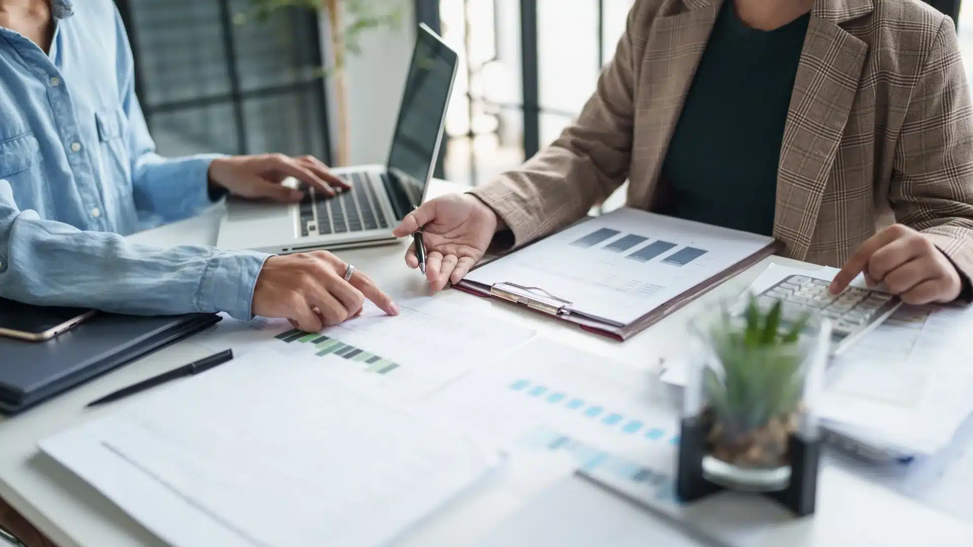 Hiring managers reviewing financial reports and candidate data during a strategic meeting, illustrating how top accounting headhunters in California help companies secure high-impact finance leaders quickly.